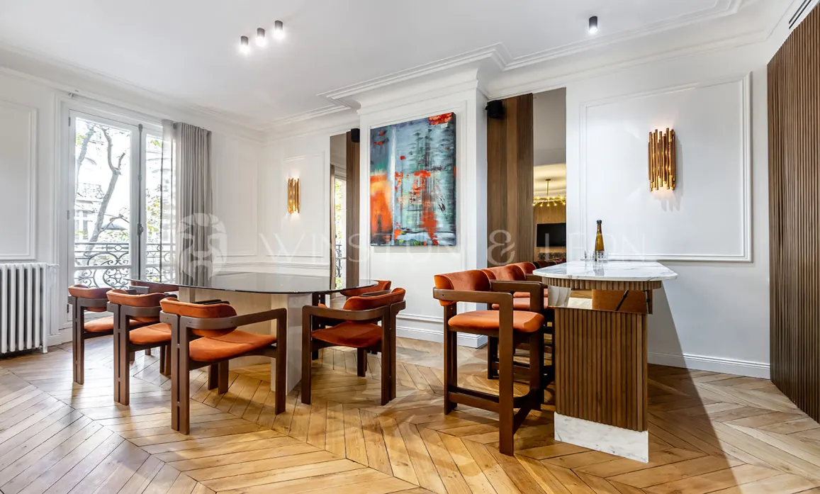 Luxury apartment: designer dining and bar area, herringbone parquet, modern art. Elegant, bright space for entertaining.