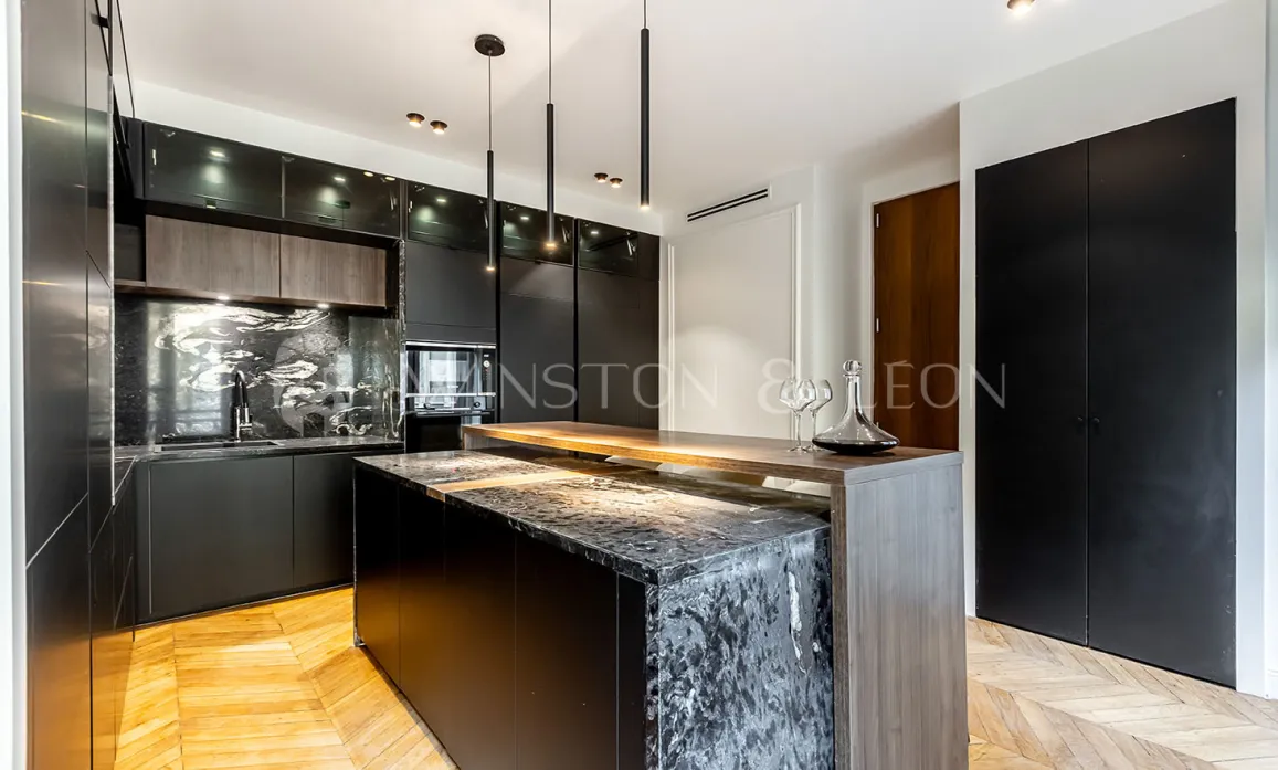 Contemporary luxury black kitchen, marble island, wood, parquet. Elegant and sophisticated design for a high-end interior.