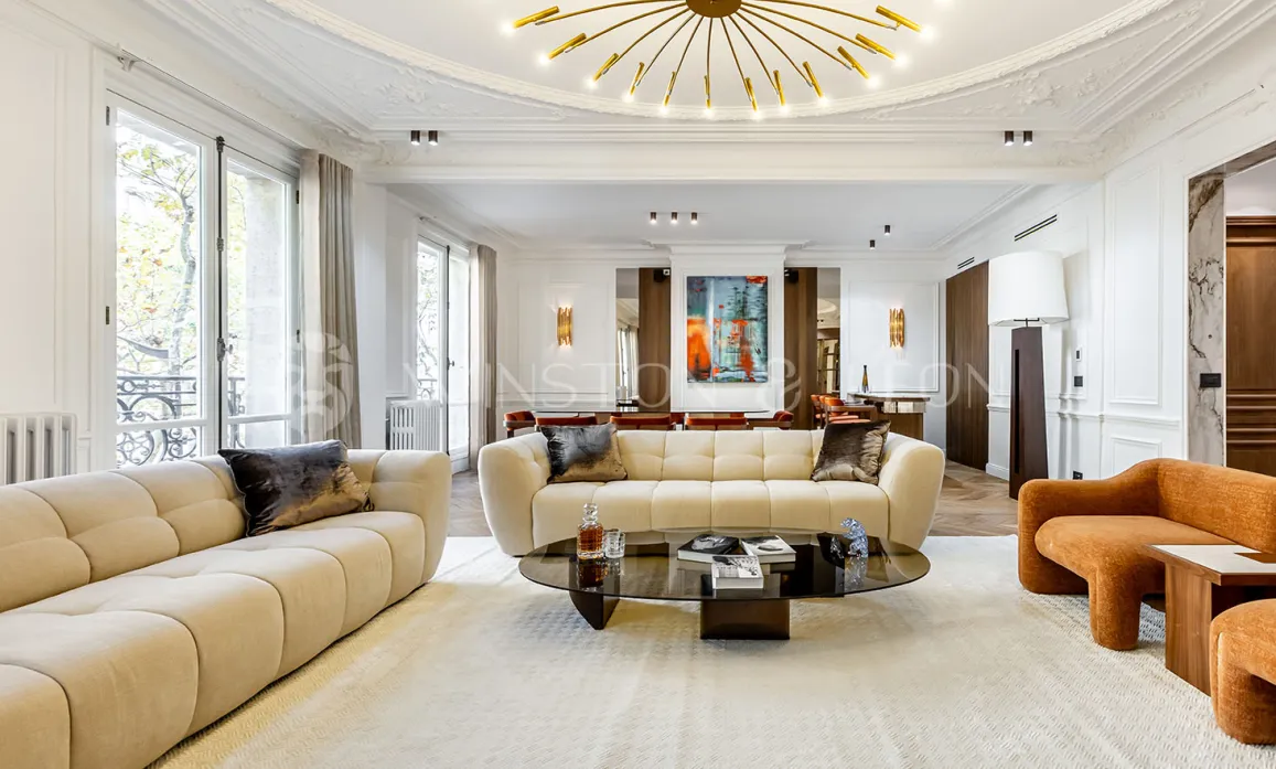 Contemporary luxury living room with designer furniture, high ceilings, large windows, and art. Elegance and comfort for an exceptional interior.