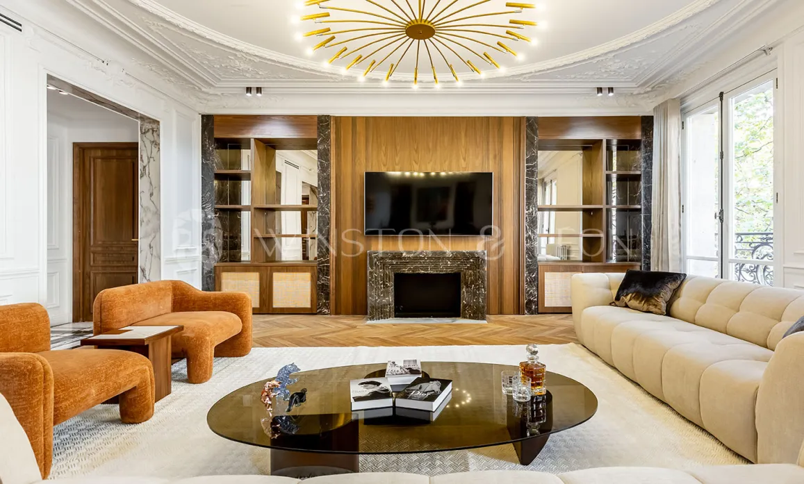 Elegant luxury living room, contemporary design, wood paneling & marble fireplace. High-end Parisian apartment. Refined ambiance.