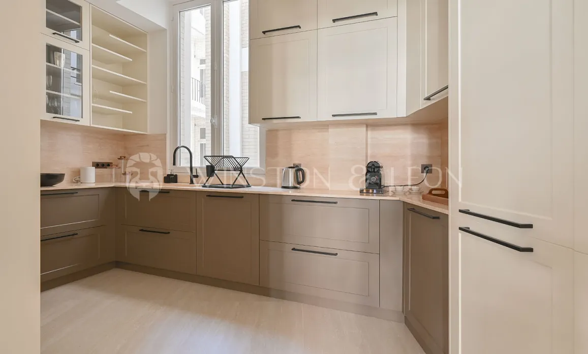 Luxury modern two-tone kitchen (beige/taupe), sleek design, premium finishes. Ideal for a contemporary apartment.