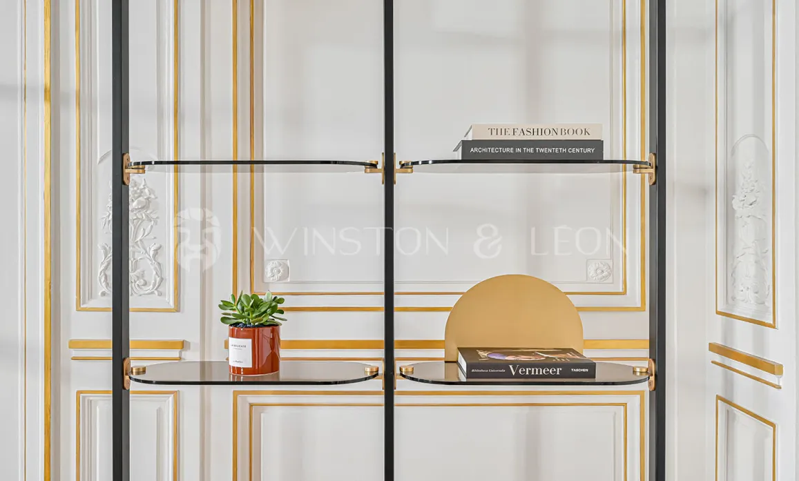 Luxury design shelf in glass and black metal, gold accents, against classic Haussmannian wall panels. Contemporary elegance and refinement.
