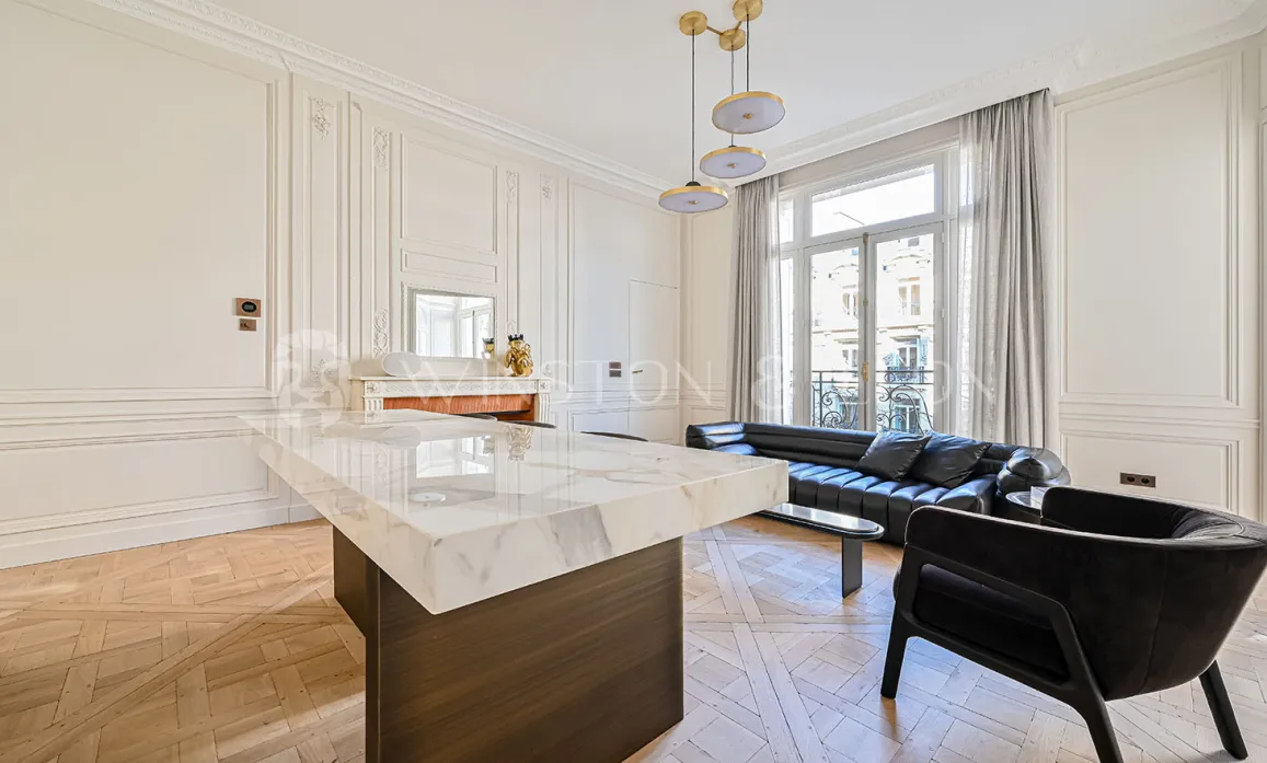 Luxury Parisian living room. Modernized Haussmannian design, marble, parquet, moldings. Elegance and prestige for a refined interior.