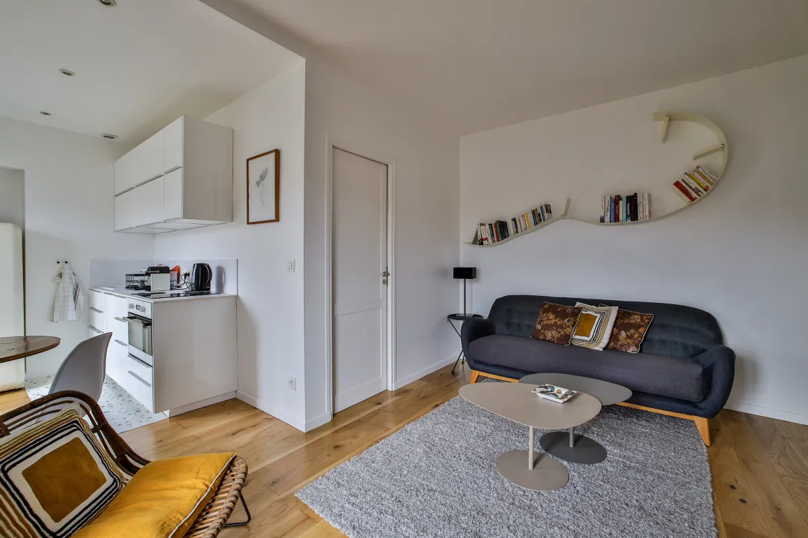 Modern luxury apartment: bright living room, open-plan designer kitchen, hardwood floors. Contemporary & elegant space.