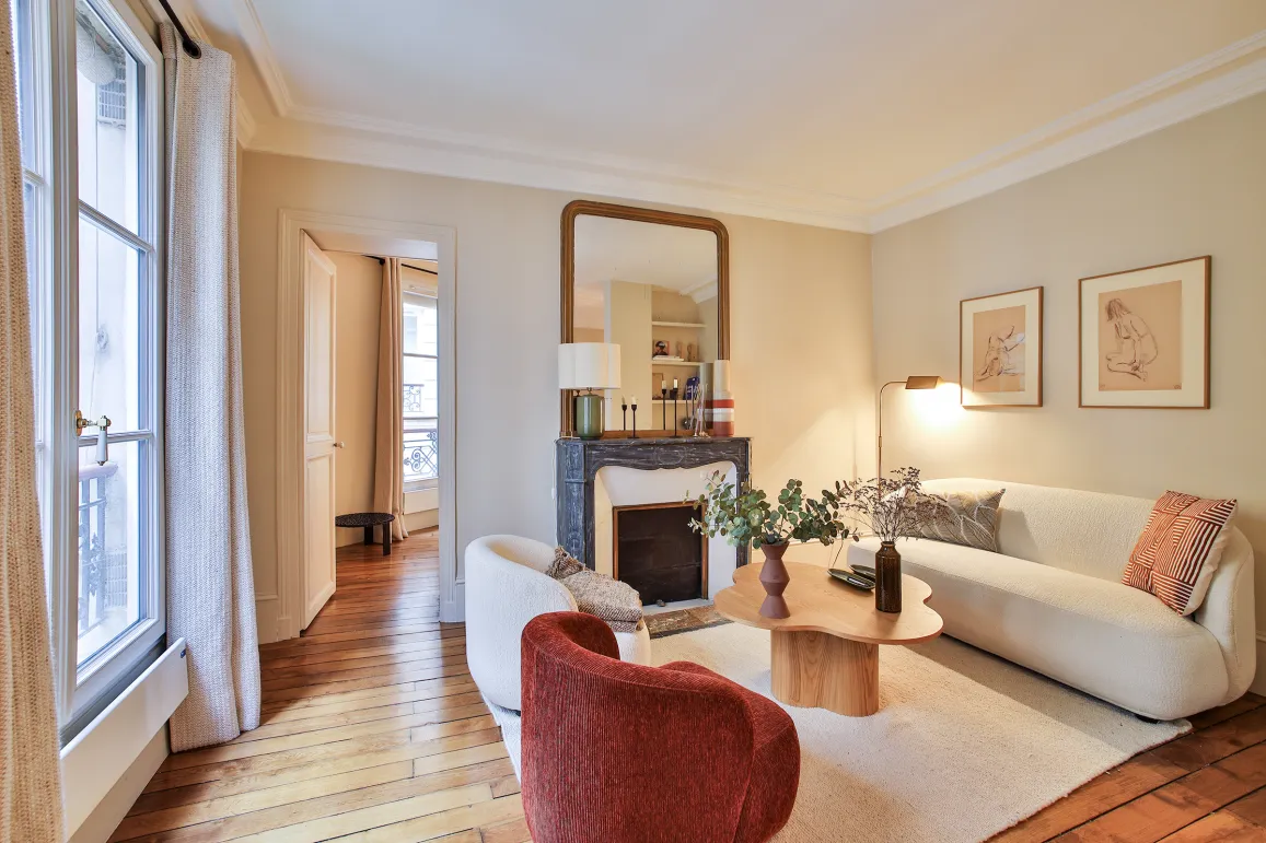 Luxury Parisian living room, modern and elegant design with fireplace, hardwood floor, natural light. Ideal for a high-end apartment.