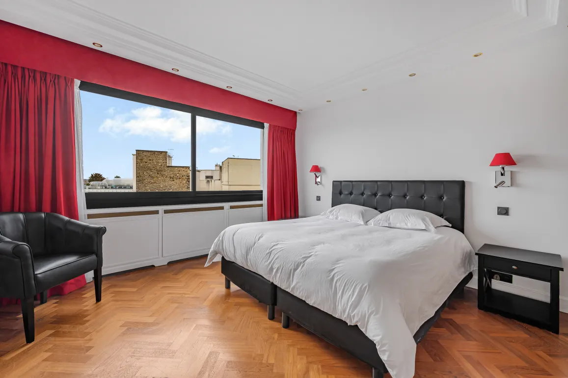 Bright luxury bedroom, city view, herringbone parquet. Elegant double bed, armchair. Perfect for high-end real estate.