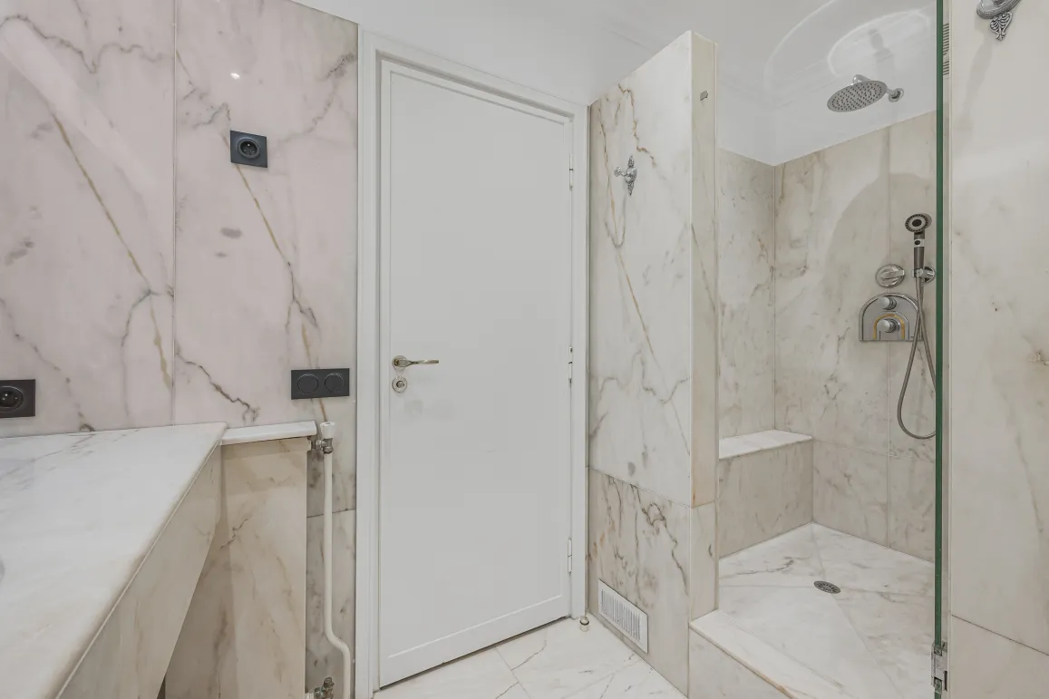 Luxury marble bathroom with modern walk-in shower. Elegant and contemporary design for high-end real estate.