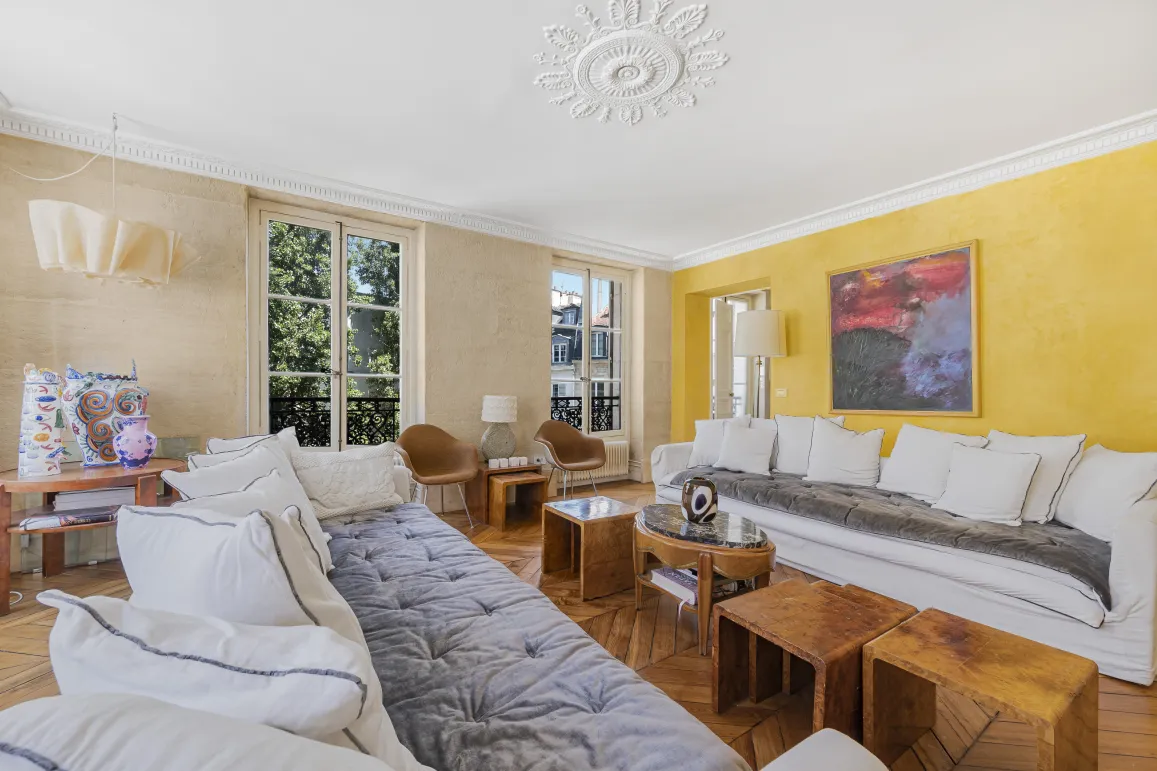 Stunning luxury living room featuring parquet, moldings, large windows, and contemporary design. Perfect for an elegant Parisian apartment.