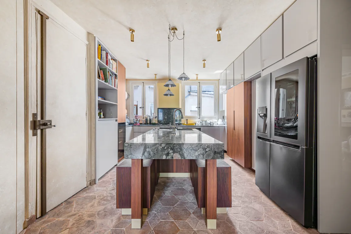Modern luxury kitchen featuring a stunning marble island, high-end appliances, and elegant design. Perfect for a Parisian apartment.