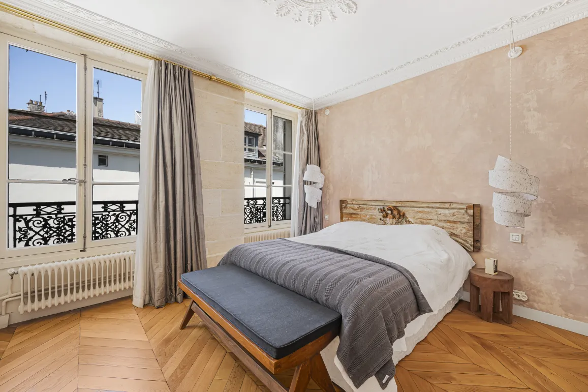 Luxury Parisian bedroom. Parquet, city view, elegant and comfortable design. Refined ambiance.