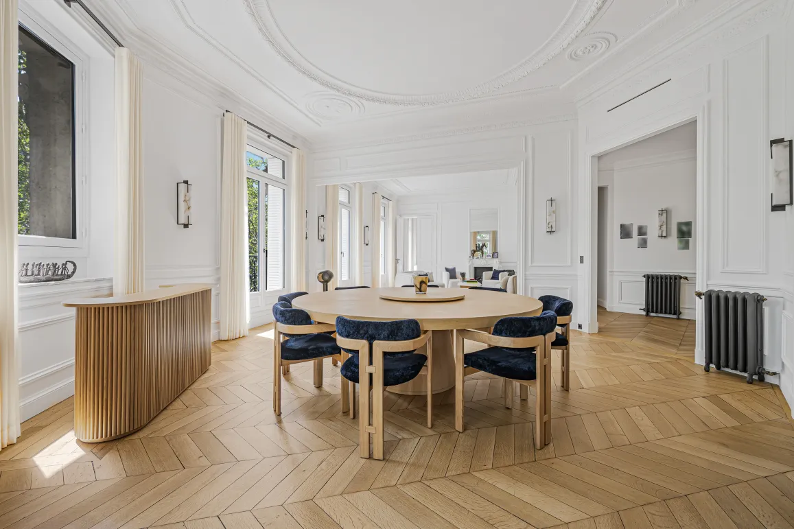 Bright luxury dining room, elegant design. Parisian apartment with herringbone parquet, moldings. Refinement and space.