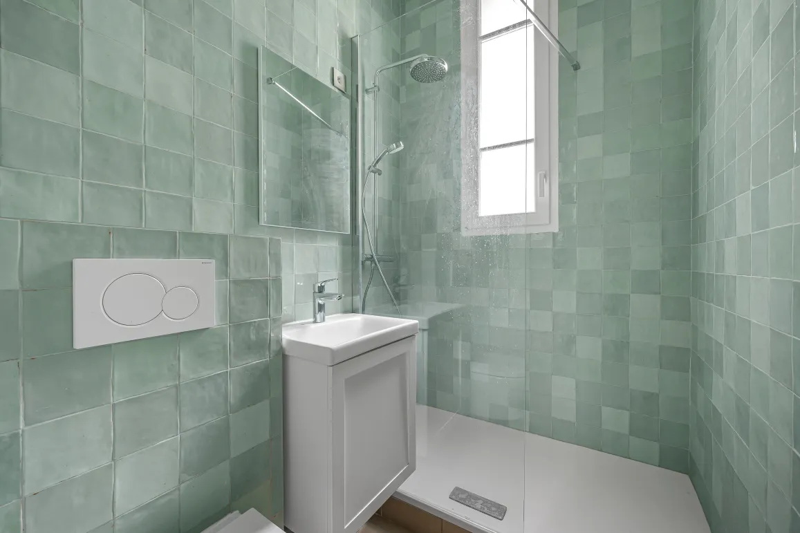 Contemporary bathroom with walk-in shower, bright mint green tiles. Minimalist design for a modern luxury interior.