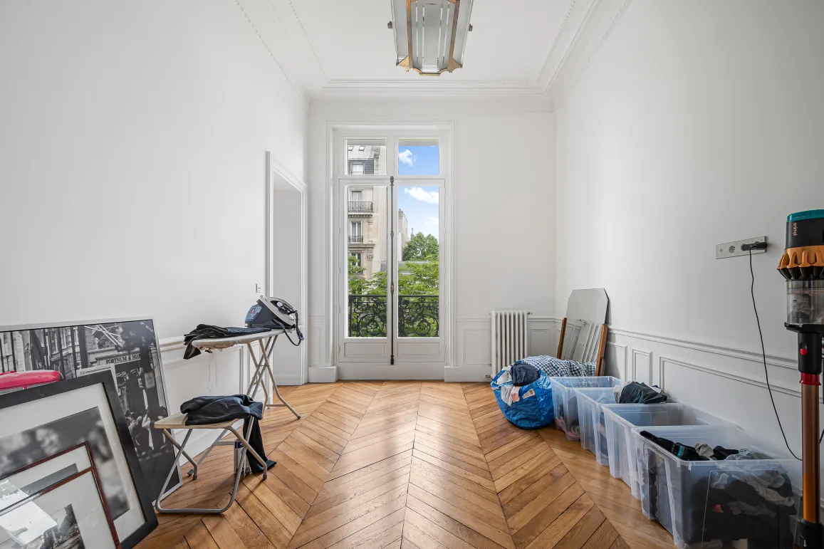 Bright Parisian Haussmann apartment. Herringbone parquet, moldings, balcony window. Luxury potential, green view.