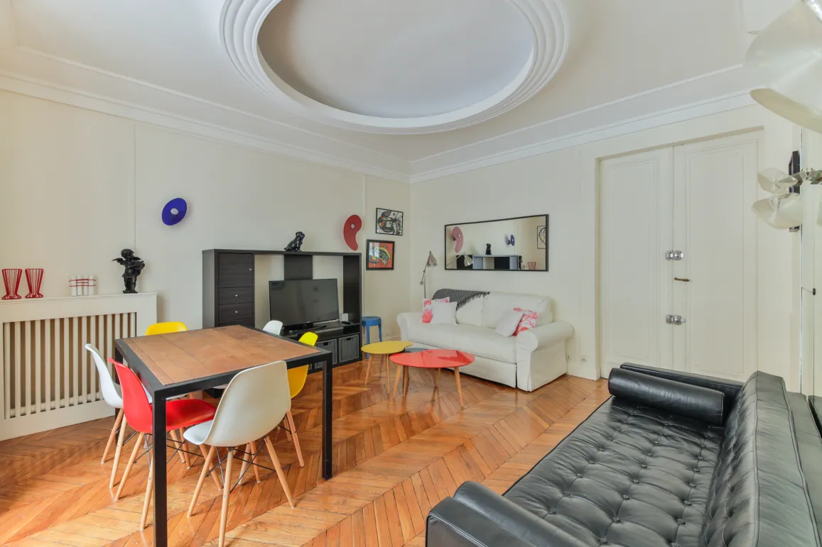 Modern luxury living-dining room. Parquet flooring, colorful designer furniture, bright space. Ideal for a prestigious apartment.