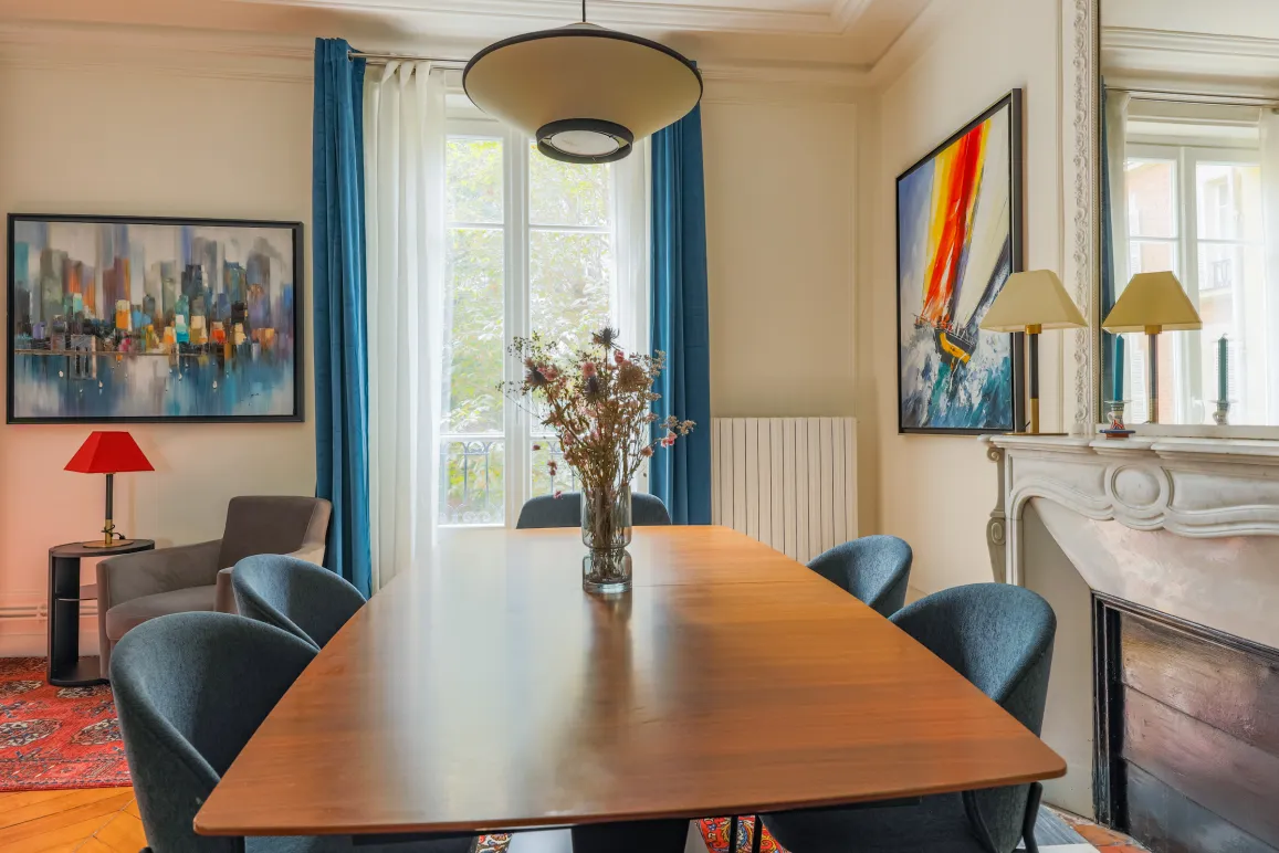Elegant, bright dining room with modern design and artistic touches. A refined space with fireplace for luxury property.