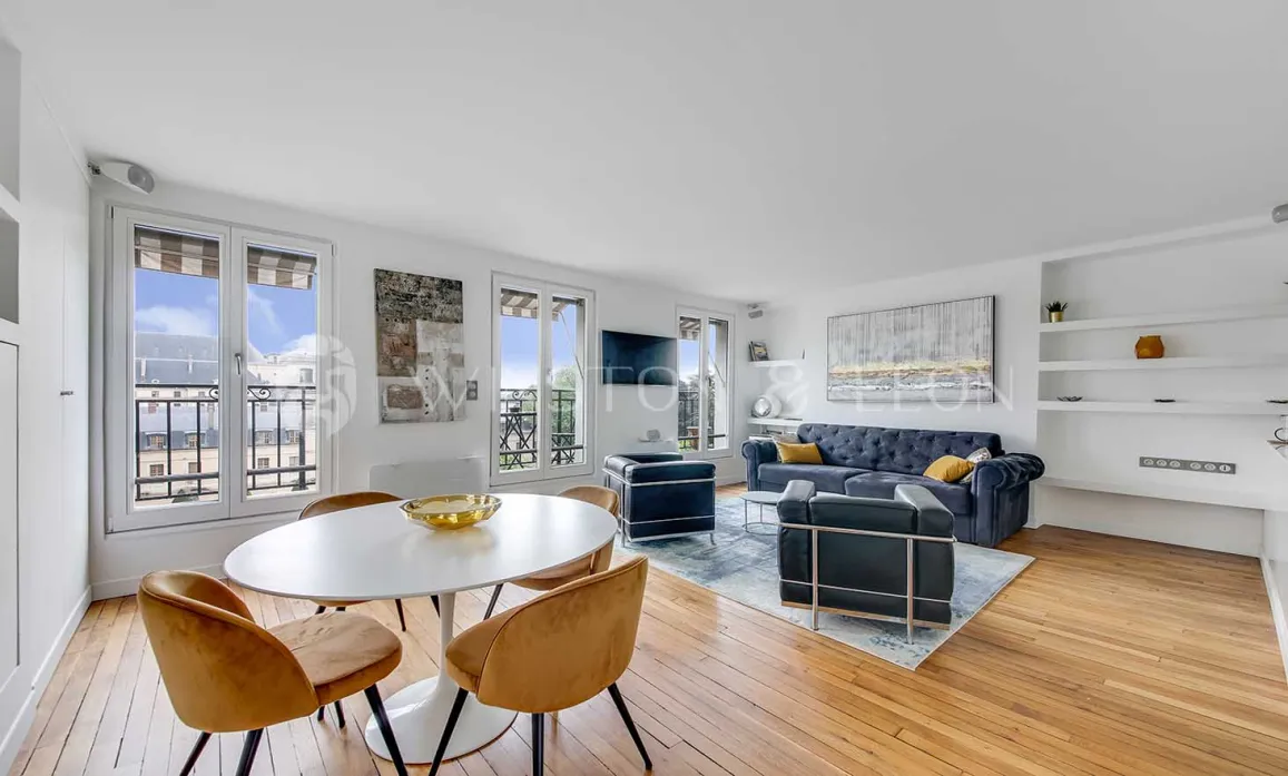 Bright luxury apartment featuring modern living/dining, hardwood floors, large windows with city views. Elegant and contemporary design.