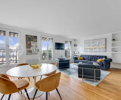 Bright luxury apartment featuring modern living/dining, hardwood floors, large windows with city views. Elegant and contemporary design.
