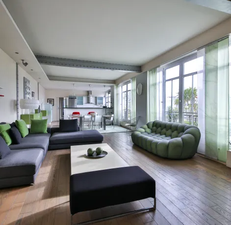 Spacious, bright luxury living room with contemporary design, open kitchen, and clear views. Perfect for a high-end apartment.