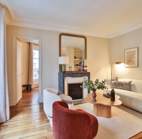 Luxury Parisian living room, modern and elegant design with fireplace, hardwood floor, natural light. Ideal for a high-end apartment.