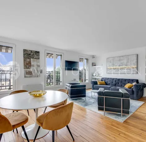 Bright luxury apartment featuring modern living/dining, hardwood floors, large windows with city views. Elegant and contemporary design.