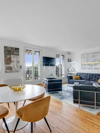 Bright luxury apartment featuring modern living/dining, hardwood floors, large windows with city views. Elegant and contemporary design.